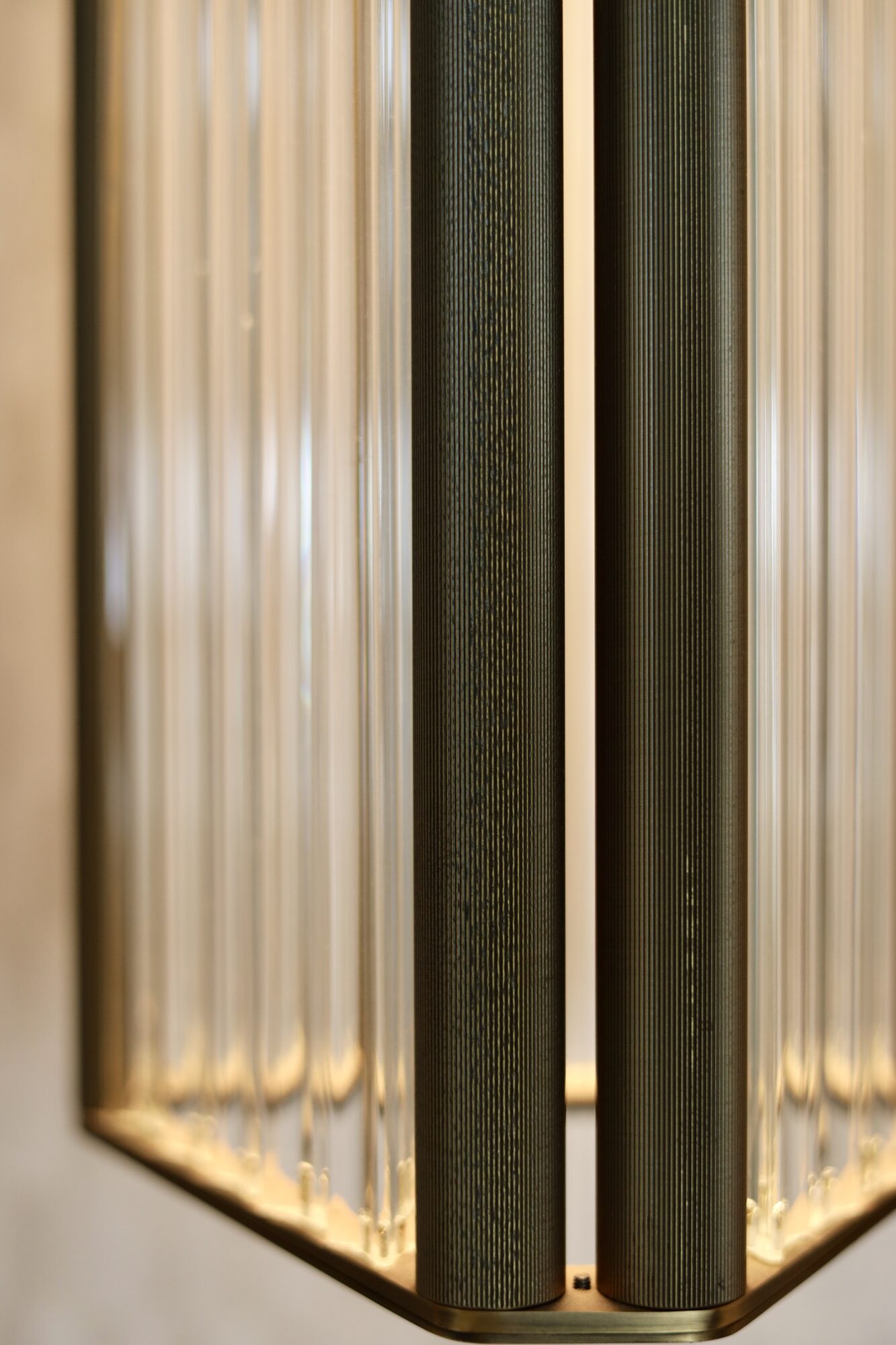 Macro detail of a precision-engineered brass and glass light fixture showing fabrication quality